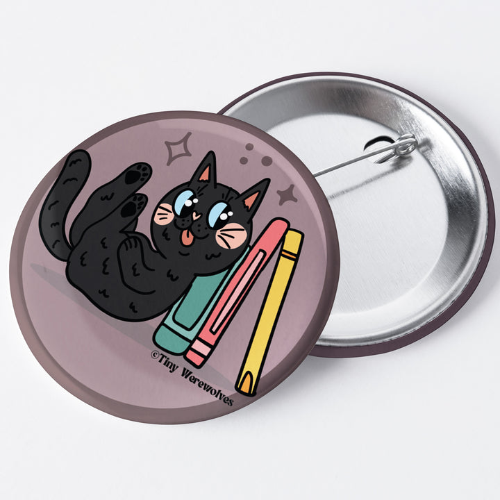 Based in Chicago by queer artist & designer Kayla Pekkala - Tiny Werewolves | Black Book Cat 1.75" Button Pin in | Shop to get your Metal Pinback Button with collections featuring retro-inspired designs infused with social commentary art, highlighting modern social & current events.