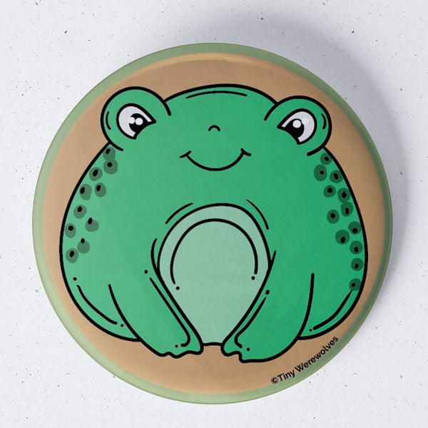 Based in Chicago by queer artist & designer Kayla Pekkala - Tiny Werewolves | Frog 1.75" Button Pin in | Shop to get your Metal Pinback Button with collections featuring retro-inspired designs infused with social commentary art, highlighting modern social & current events.