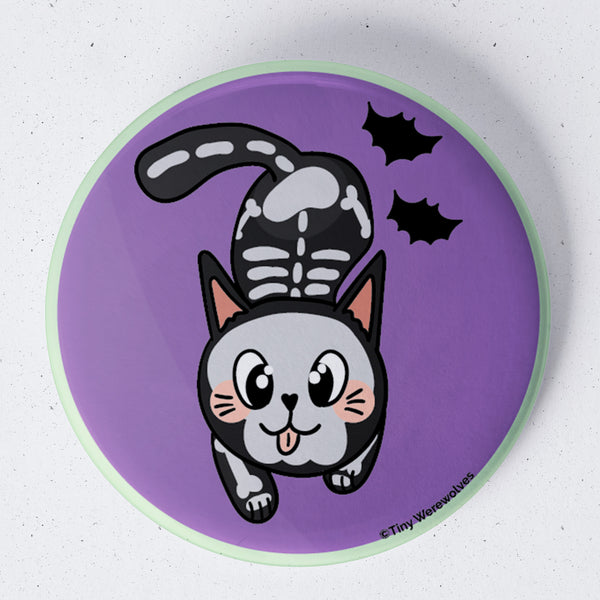 Based in Chicago by queer artist & designer Kayla Pekkala - Tiny Werewolves | SkeliCat Spooky 1.75" Button Pin in | Shop to get your Metal Pinback Button with collections featuring retro-inspired designs infused with social commentary art, highlighting modern social & current events.