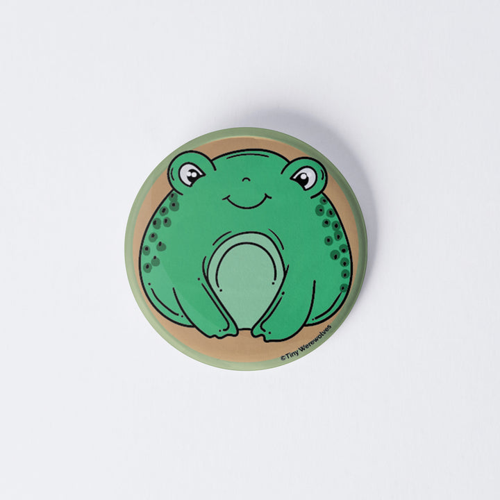 Based in Chicago by queer artist & designer Kayla Pekkala - Tiny Werewolves | Frog 1" Mini Button Pin in | Shop to get your Metal Pinback Button with collections featuring retro-inspired designs infused with social commentary art, highlighting modern social & current events.