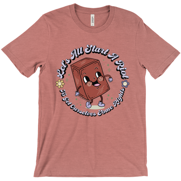 Based in Chicago by queer artist & designer Kayla Pekkala - Tiny Werewolves | Let's All Start A Riot Tee in Heather Mauve | Shop to get your Tee with collections featuring retro-inspired designs infused with social commentary art, highlighting modern social & current events.