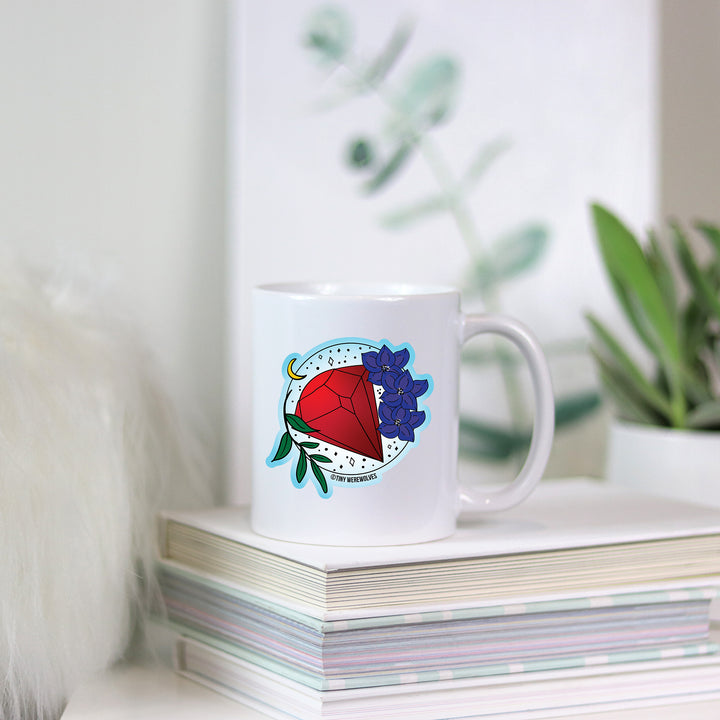 Based in Chicago by queer artist & designer Kayla Pekkala - Tiny Werewolves | July Crystal & Flower Birthstone Mug in | Shop to get your Mug with collections featuring retro-inspired designs infused with social commentary art, highlighting modern social & current events.